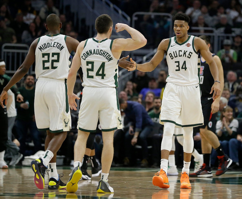Milwaukee Bucks' Giannis Antetokounmpo (34) celebrates with Pat Connaughton (24) and Khris Middleton (22) during the first half of an NBA basketball game against the Los Angeles Clippers, Thursday, March 28, 2019, in Milwaukee. (AP Photo/Aaron Gash)