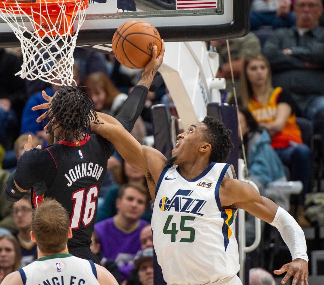 (Rick Egan  |  The Salt Lake Tribune)     Utah Jazz guard Donovan Mitchell (45) stops Miami Heat forward James Johnson (16) from scoring, but is called for a foul on the play, in NBA action between Utah Jazz and Miami Heat, at Vivint Smart Home Arena Wednesday, Dec. 12, 2018.