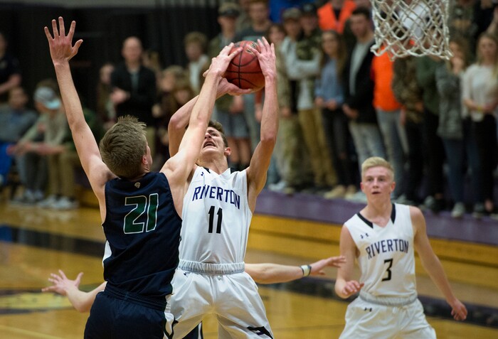 Scott Sommerdorf | The Salt Lake TribuneRiverton's Dayne McDonald has his shot blocked by Joseph Wilson during first half play. Copper Hills defeated Riverton 54-50, Friday, February, 2, 2018. 