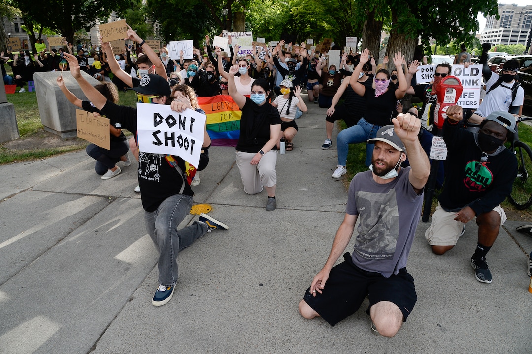 (Francisco Kjolseth  |  The Salt Lake Tribune) Demonstrators take a knee as they try and encourage law enforcement to do the same as they protest against police brutality on Tuesday, June 2, 2020, in downtown Salt Lake City, as an 8 p.m. weeklong curfew remains in order.
