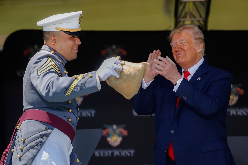(John Minchillo | AP pool photo)
United States Military Academy graduating cadet Chase Turnquest Miller, of Princeton Junction, N.J., receives the traditional bag of money in collections from his peers and delivered by President Donald Trump after graduating as the class "goat," or lowest ranking class member,during commencement ceremonies, Saturday, June 13, 2020, in West Point, N.Y.