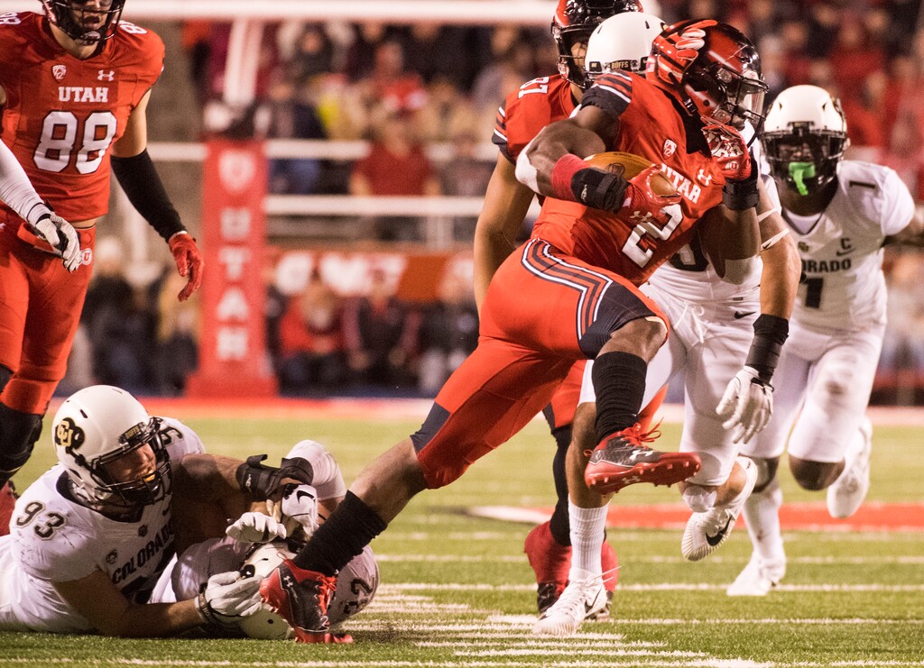 Utah running back Zack Moss (2) brake a tackle as he runs the ball for the Utes, in PAC-12 football action Utah Utes vs. Colorado Buffaloes at Rice-Eccles stadium, Saturday, November 25, 2017.