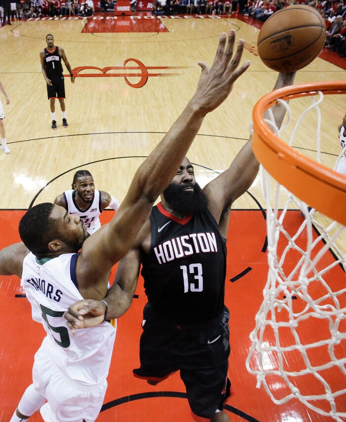Houston Rockets guard James Harden (13) drives to the basket as Utah Jazz forward Derrick Favors defends during the second half in Game 2 of an NBA basketball second-round playoff series, Wednesday, May 2, 2018, in Houston. (AP Photo/Eric Christian Smith)