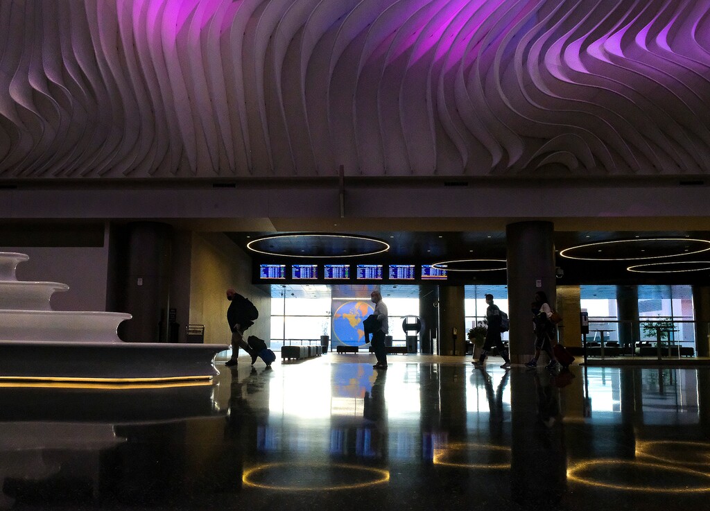 (Leah Hogsten | The Salt Lake Tribune) Travelers walk through Salt Lake City International Airport, March 13, 2021. The airport is a lone bastion of relaxed liquor laws in Utah.