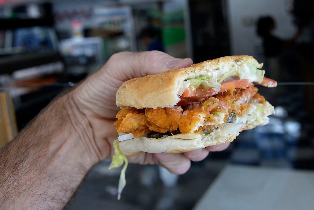 (Al Hartmann  |  The Salt Lake Tribune)  Tribune photographer Al Hartmann heartily concurs that the best chicken sandwich he's ever had is this one from Kevin's Fried Chicken, located inside the Food Mart/Gas Station at 524 W. 4500 South in Murray.  Owner Kevin Nguyen has a secret recipe for the spicy breading, using real chicken pieces (not pressed).