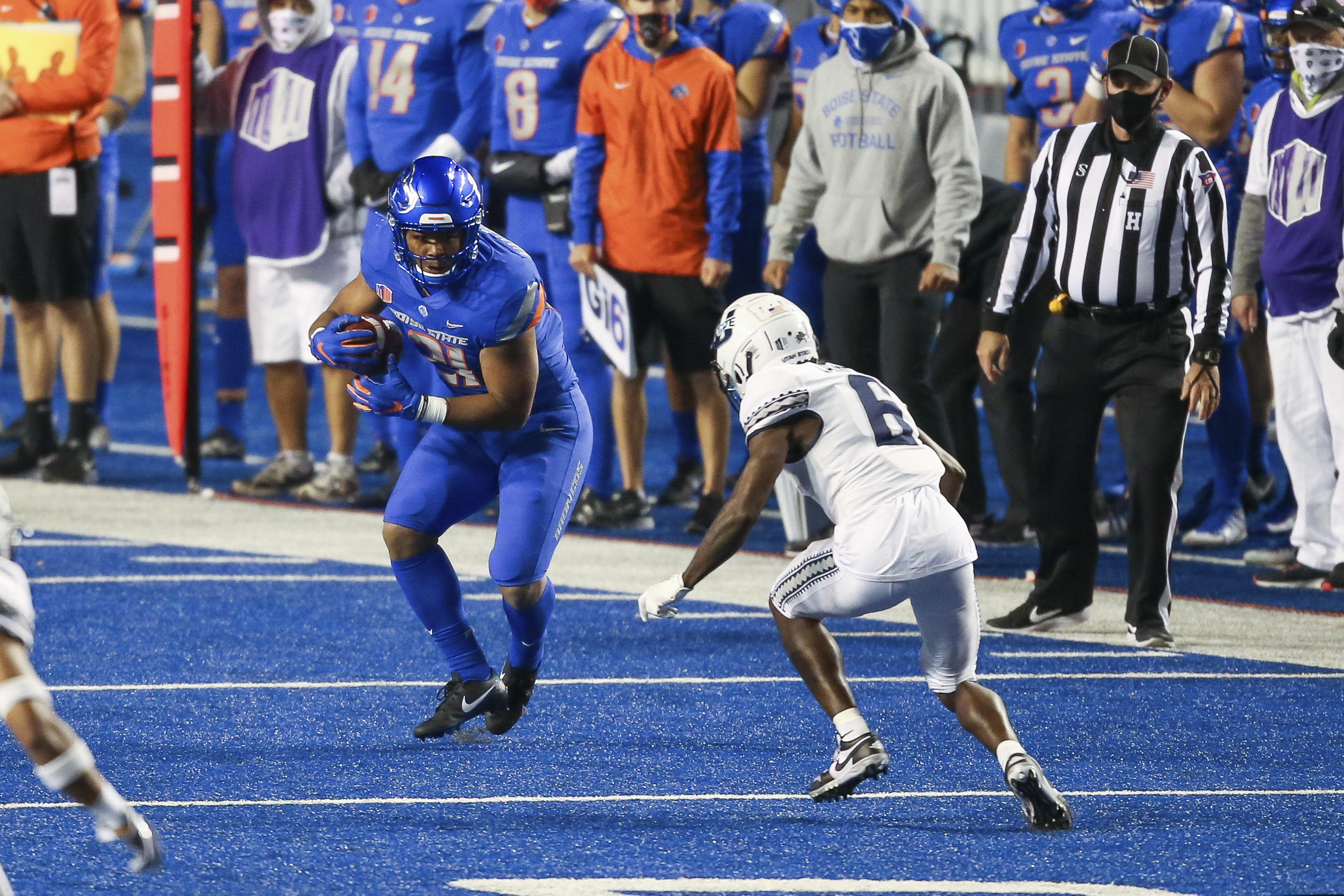 Boise State running back Andrew Van Buren (21) turns up field after a reception as Utah State cornerback Cam Lampkin (6) closes in during the second half in an NCAA college football game Saturday, Oct. 24, 2020, in Boise, Idaho. Boise State won 42-13. The young Aggies face another tough opponent when San Diego State comes to Logan on Saturday, Oct. 31, 2020 (AP Photo/Steve Conner)