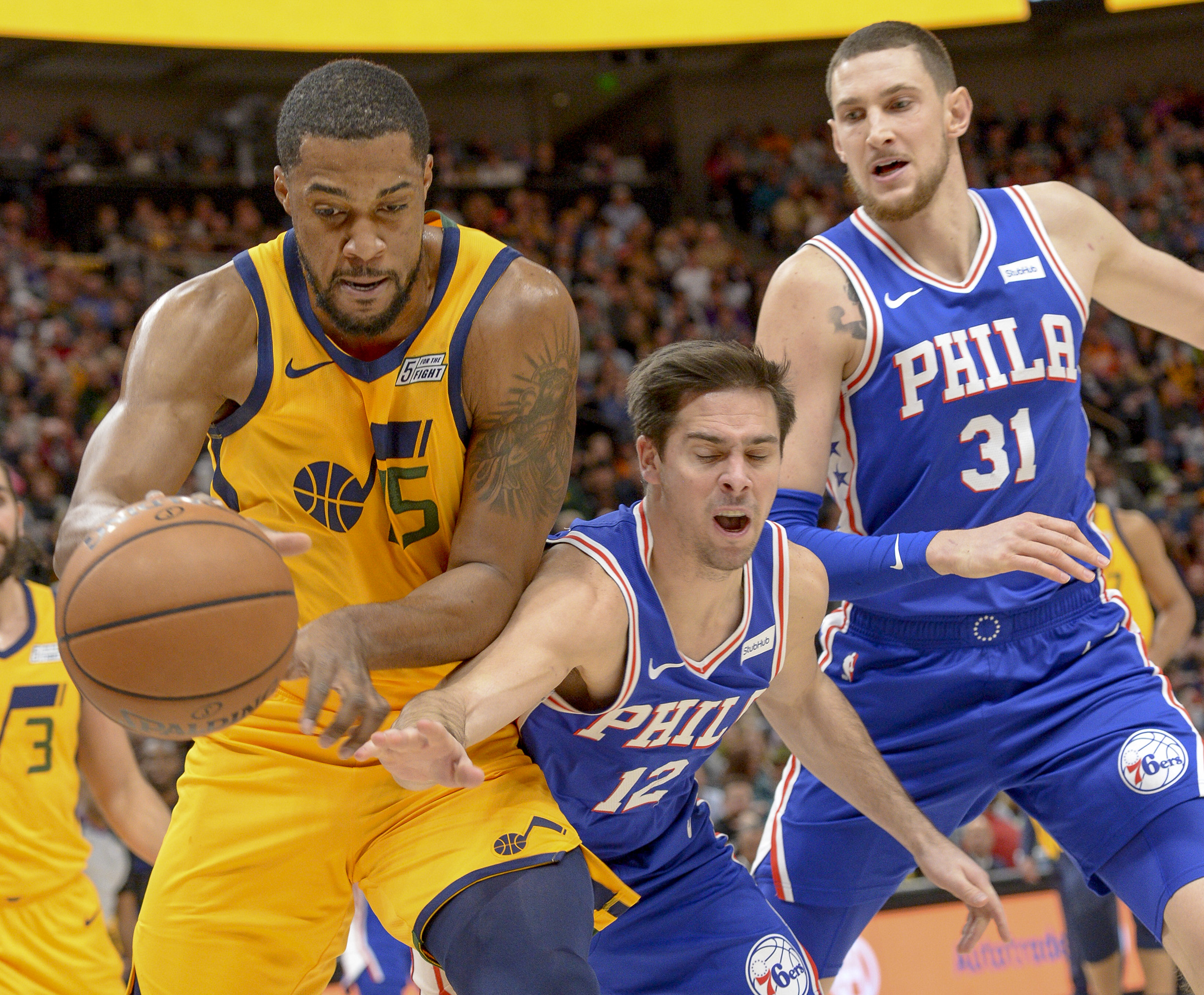 Leah Hogsten  |  The Salt Lake Tribune Utah Jazz forward Derrick Favors (15) pulls in the rebound over Philadelphia 76ers guard T.J. McConnell (12)  as the Utah Jazz host the Philadelphia 76ers at Vivint Smart Home Arena, Thursday, December 27, 2018. 