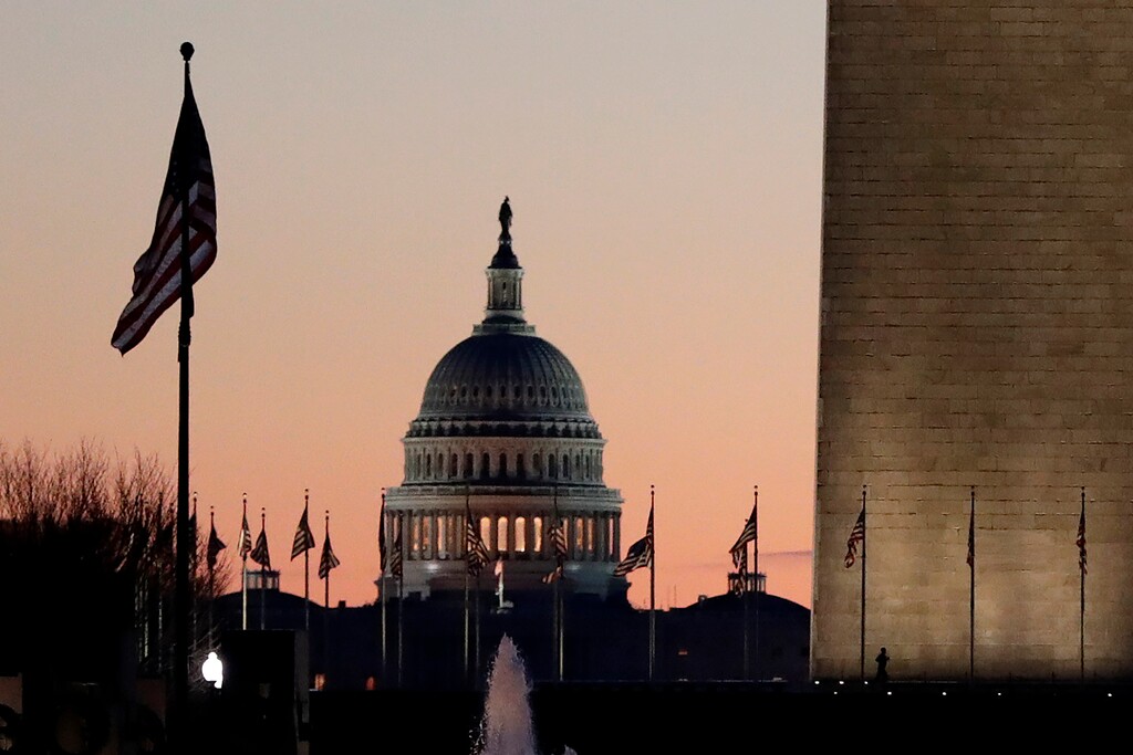 (AP Photo/Julio Cortez) The U.S. Capitol building, center, and part of the Washington Monument, right, are seen at sunrise, Wednesday, Dec. 18, 2019, on Capitol Hill in Washington.