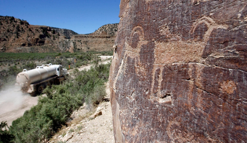 (Al Hartmann | Salt Lake Tribune) Water trucks make their way along the dirt road in Nine Mile Canyon in 2010.