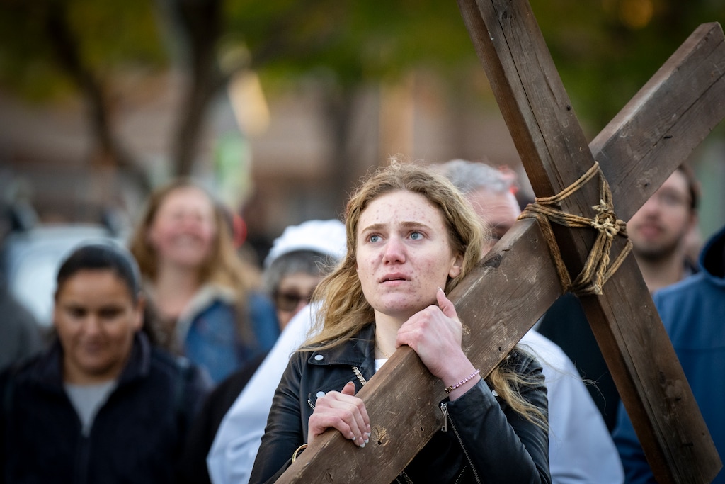 (Rick Egan | The Salt Lake Tribune) Brooke Austin carries the cross during the Good Friday procession on Friday, April 3, 2026.