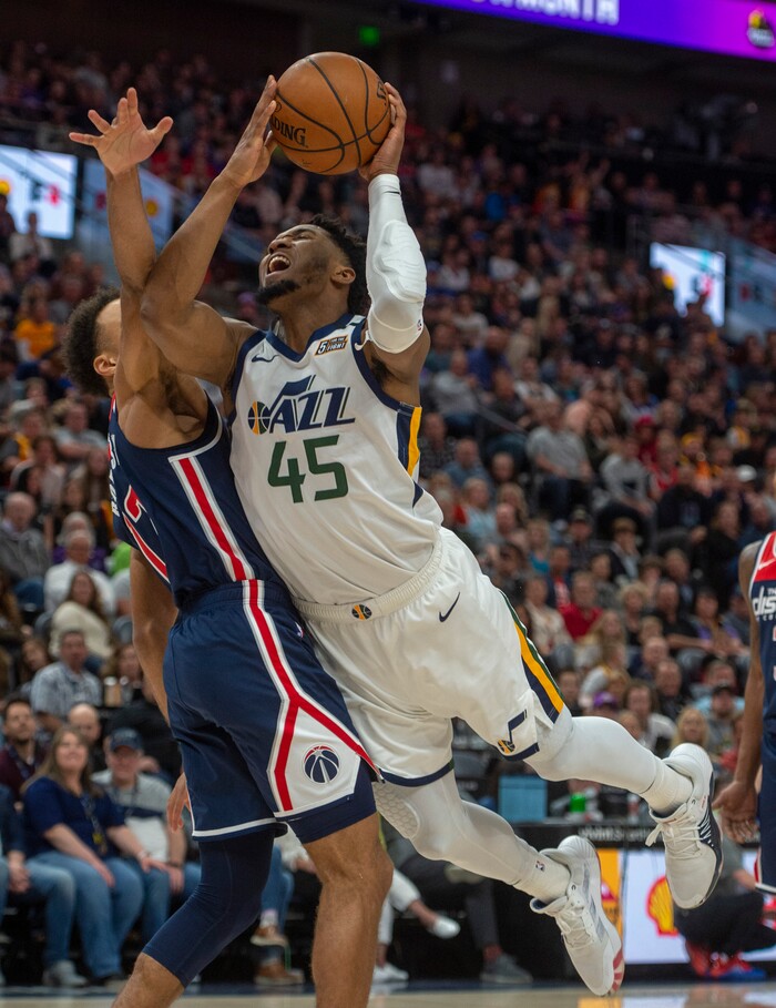 (Rick Egan  |  The Salt Lake Tribune)   Utah Jazz guard Donovan Mitchell (45) draws a foul as Washington Wizards guard Jerome Robinson (12) stops him from scoring, as he goes to the hoop, in NBA action between the Utah Jazz and the Washington Wizards, in Salt Lake City, Friday, February 28, 2020