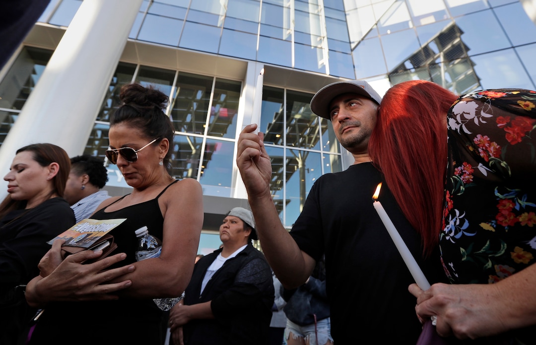 (Gregory Bull  |  AP Photo)  Joe Thomas hugs Elizabeth Reitz, right, during a vigil at City Hall in Las Vegas, Monday, Oct. 2, 2017. The vigil was held in honor of the over 50 people killed and hundreds injured in a mass shooting at an outdoor music concert late Sunday.