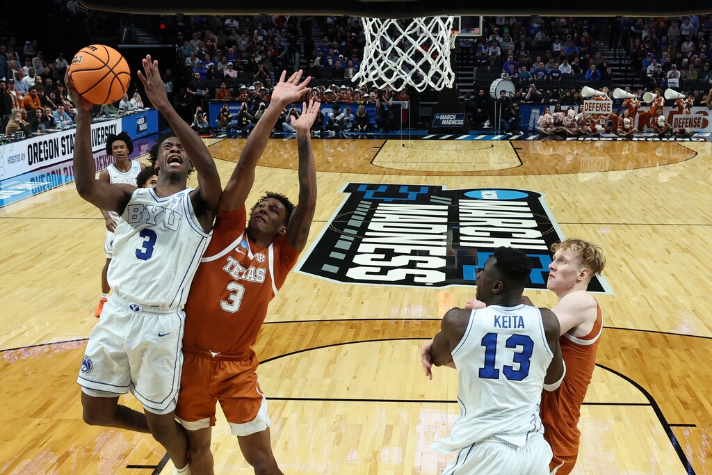 (Craig Mitchelldyer | AP) BYU forward AJ Dybantsa (3) shoots as Texas forward Dailyn Swain (3) defends during the second half in the first round of the NCAA college basketball tournament Thursday, March 19, 2026, in Portland, Ore. 