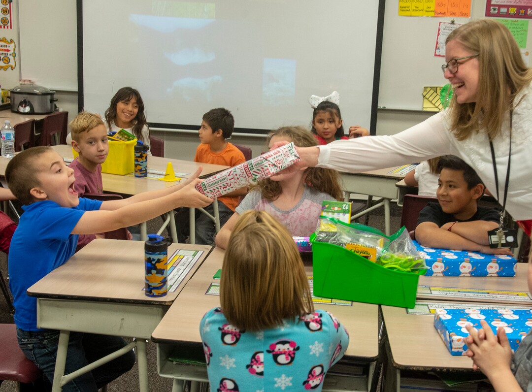 (Rick Egan  |  The Salt Lake Tribune)  Ms. Worthington the principal of Oquirrh Elementary hands out cereal to a third grade class. She surprised all 650 students at her school with the gift-wrapped boxes of cereal, West Jordan, Thursday, Dec. 20, 2018.