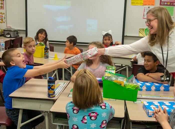 (Rick Egan  |  The Salt Lake Tribune)  Ms. Worthington the principal of Oquirrh Elementary hands out cereal to a third grade class. She surprised all 650 students at her school with the gift-wrapped boxes of cereal, West Jordan, Thursday, Dec. 20, 2018.


