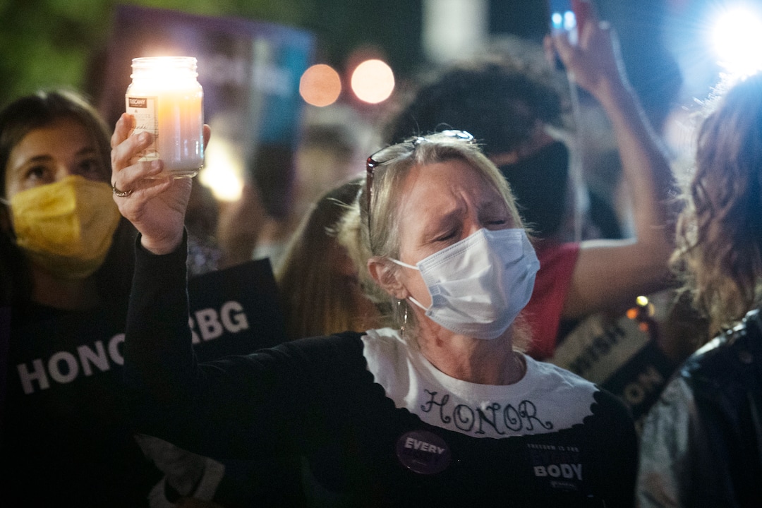 Gwendolyn Howard, of Fairfax, Va., takes part in a vigil, at the Supreme Court, to honor the late Justice Ruth Bader Ginsburg, Saturday, Sept. 19, 2020 in Washington. (AP Photo/Cliff Owen)