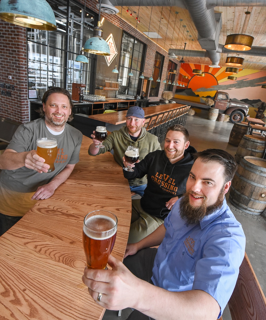 (Francisco Kjolseth  |  The Salt Lake Tribune) Sharing a beer in the space they created are Level Crossing Brewing Co. owner Mark Medura, left, Andrew Madsen of Madcraft Sign and Fabrication Co., Eric Stonehill, Project Manager and Chris Detrick, head brewer.
