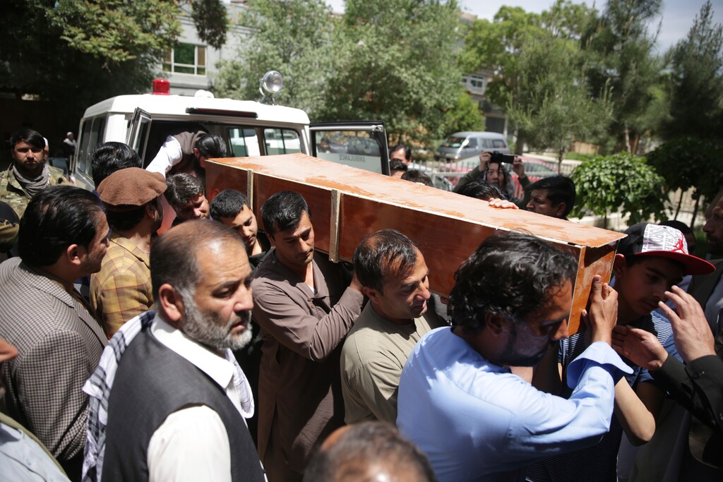(AP Photo/Massoud Hossaini) Relatives of an AFP photojournalist who was killed carry his coffin in Kabul, Afghanistan, Monday, April 30, 2018. A coordinated double suicide bombing by the Islamic State group hit central Kabul on Monday morning, killing at least 25 people, including eight journalists, officials said.