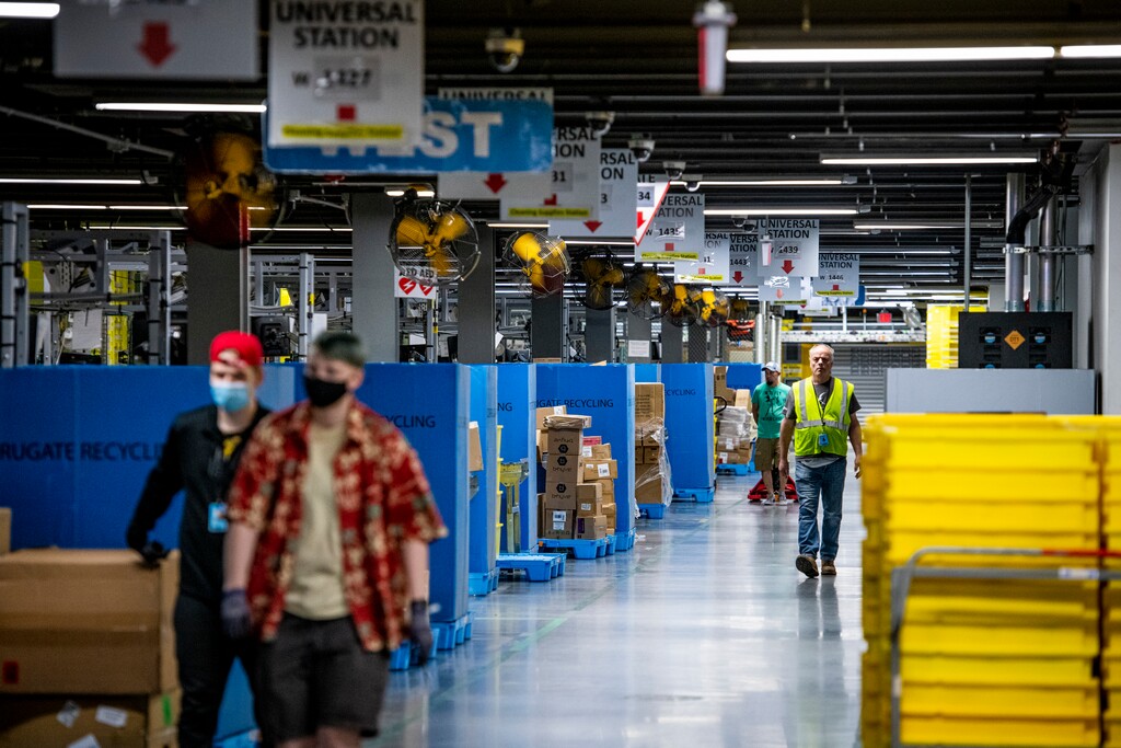 (Isaac Hale | Special to The Tribune) Employees walk around during a tour of the Amazon Fulfillment Center located at 777 N. 5600 West in Salt Lake City on Thursday, June 10, 2021.