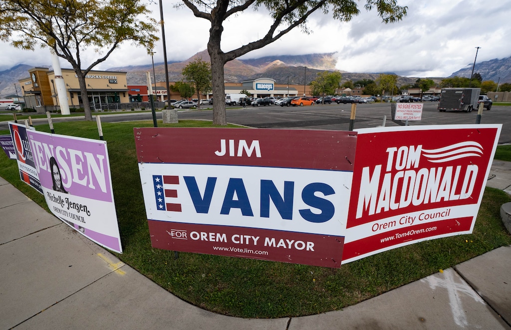 (Francisco Kjolseth | The Salt Lake Tribune) Campaign signs are seen on the corner of 800 N. and State Street in Orem on Saturday, Oct. 9, 2021. The owners of University Place mall who own the real estate there are requiring candidates to sign an agreement to support continued development at the site in order to have permission to place signs there, an agreement some candidates are saying is unethical.