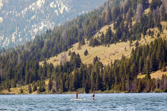 Visitors float stand-up paddle boards over Alturas Lake on August 20, 2017 near Stanley, Idaho. (Erin Alberty  |  The Salt Lake Tribune)