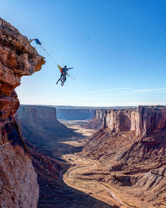 (Courtesy photo by BASE Jump Moab) Andy Lewis, a Moab-based BASE jumping guide, and a client leap into Mineral Canyon for a parachute ride at a site called the Fruit Bowl. The BLM is now seeking to ban "aerial" sports, including slacklining and climbing, throughout Mineral and neighboring Hell Roaring Canyon to protect sensitive wildlife.