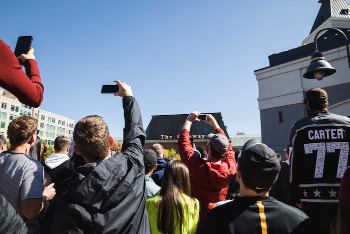 (Clark Clifford  |  Special to The Salt Lake Tribune) Spectators reach for a better photo of Kanye West's Sunday Service at The Gateway in Salt Lake City on Saturday, Oct. 5, 2019.