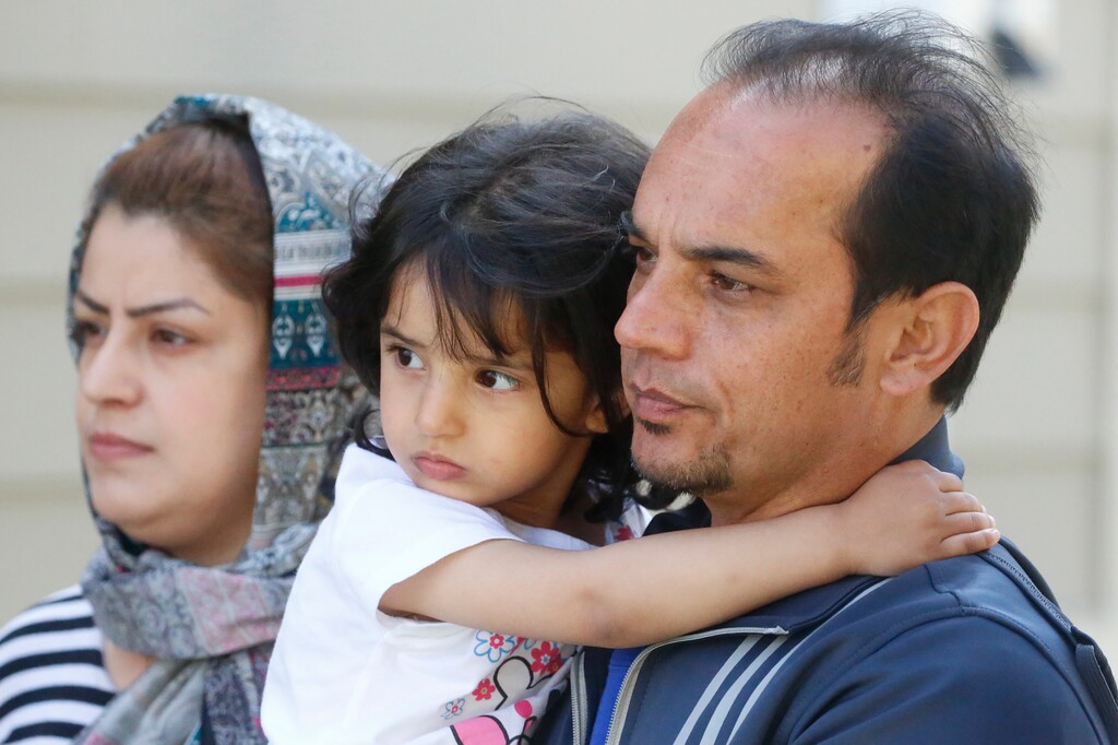 (Rick Bowmer | The Associated Press) In this April 22, 2020, photo, Afghan refugee Mahmood Amiri poses with daughter Safa, and his wife Masouda, in West Valley City, Utah. Coronavirus restrictions have affected refugee families in the same ways as anyone else — job losses, child care challenges — but many are navigating the turmoil in a language they don't fully understand and without extended family or close friends to help. Amiri arrived in the United States more than a month ago, but his children are still waiting for their first day at school and the family has yet to go to the mosque to meet fellow Muslim families.