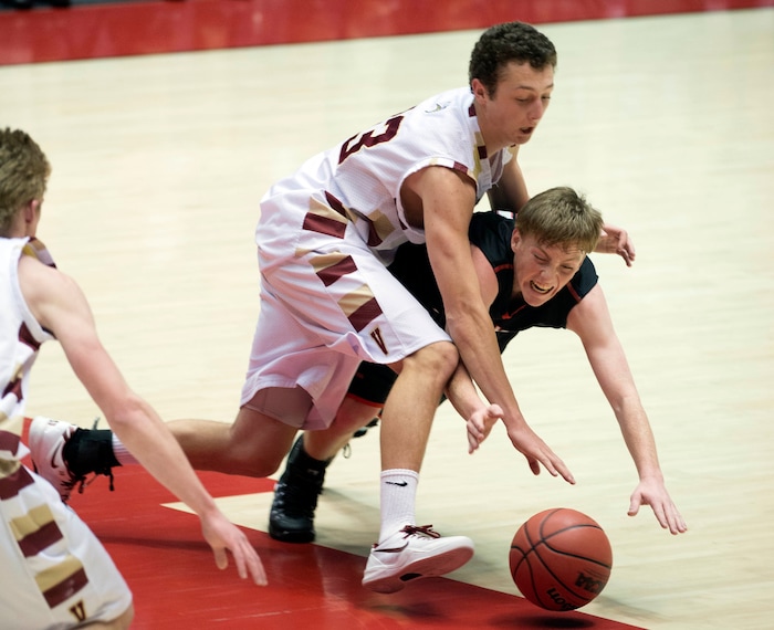 (Tribune File Photo)  American Fork's Braden Condie and Viewmont's McKay Johnson (13), top, dive for a loose ball during the boys 5A high school basketball playoffs at the Huntsman Center in Salt Lake City, March 4, 2014.