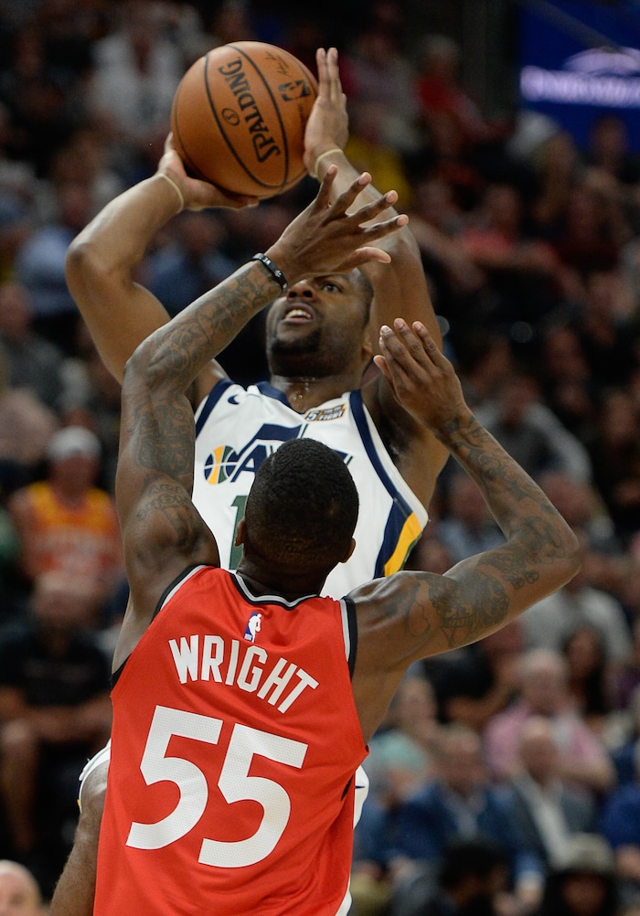 (Francisco Kjolseth  |  The Salt Lake Tribune)  Toronto Raptors guard Delon Wright (55) tries to block Utah Jazz guard Alec Burks (10) in the first half of the preseason NBA game at Vivint Smart Home Arena Tuesday, Oct. 2, 2018, in Salt Lake City.