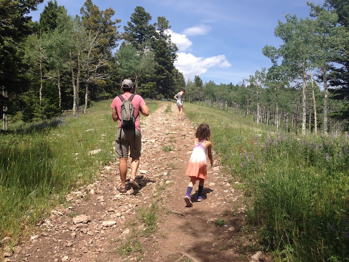 (Erin Alberty|The Salt Lake Tribune) Imogen Nesse, 5, pursues the "Trail Troll" with her parents, Melissa Helquist and Will Nesse, above the Limber Flag yurt July 4, 2015 in the Ashley National Forest. The "Trail Troll" is a mystical creature that drops gummy worms along steep trails — but only for children who don't whine.