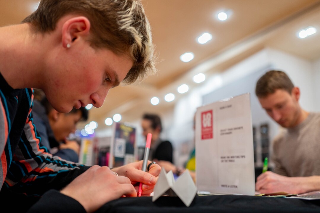 (Trent Nelson  |  The Salt Lake Tribune) Benji Miner writes a note as part of the Love Letters project, at the Urban Arts Gallery in Salt Lake City on Friday, Jan. 17, 2020.