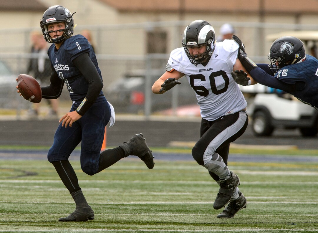 (Steve Griffin  |  The Salt Lake Tribune)  Corner Canyon quarterback Zach Wilson scrambles away from Highland  lineman Caden Hilborn during the Class 5A state quarterfinal football game at Corner Canyon in Draper Friday November 3, 2017.