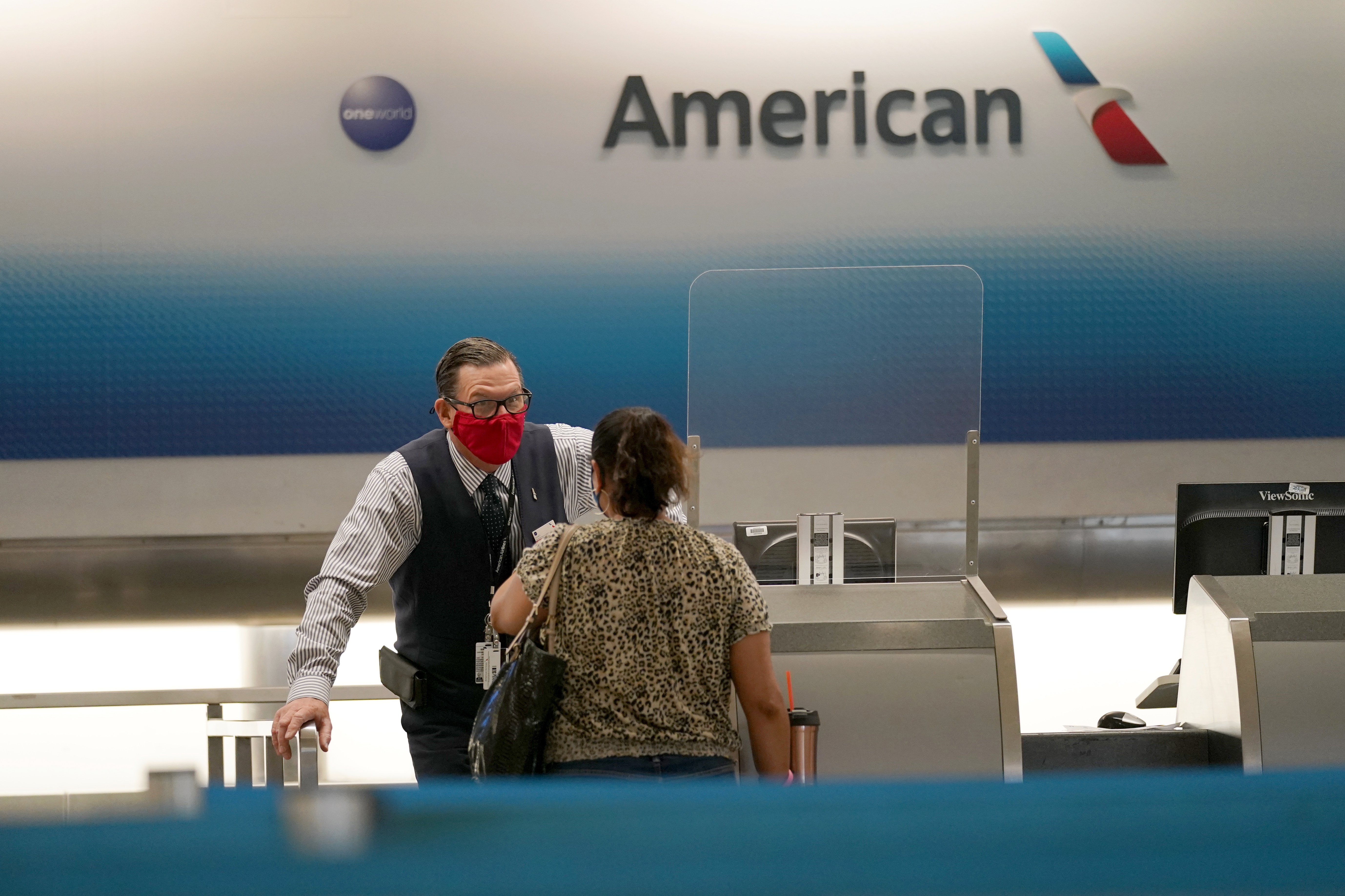 (Lynne Sladky| The Associated Press)
American Airlines ticket agent Henry Gemdron, left, works with a customer at Miami International Airport during the coronavirus pandemic, Wednesday, Sept. 30, 2020, in Miami. The airline industry has been decimated by the pandemic. The Payroll Support Program given to the airlines as part of the CARES Act runs out Thursday.