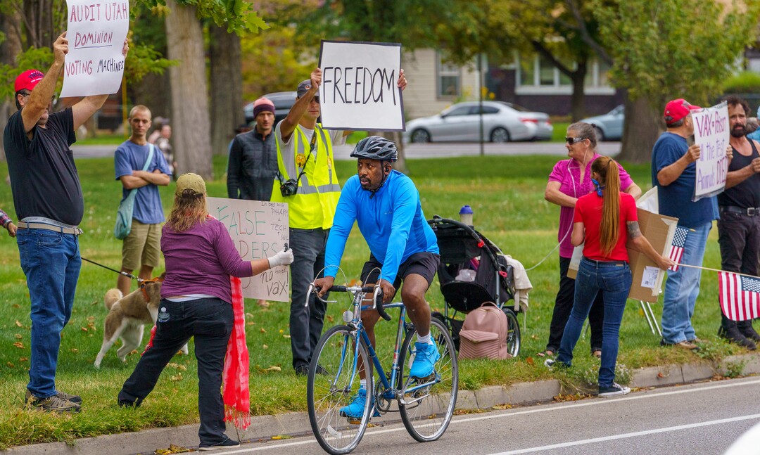 (Leah Hogsten | The Salt Lake Tribune) Protesters waving American flags and holding signs decrying mask and vaccine mandates gathered along the curb of 700 East in Liberty Park Saturday, making Salt Lake City one of dozens of cities around the world protesting public health-related restrictions, Sept. 18, 2021.