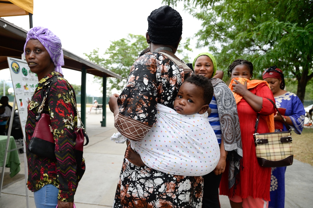 (Francisco Kjolseth  |  The Salt Lake Tribune)   Women line up to pick out vegetables at the Sunnyvale Farmers Market at 4013 S. 700 West, which draws a weekly refugee clientele on Saturday, July 13, 2019, selling food grown exclusively by refugees living in Utah.