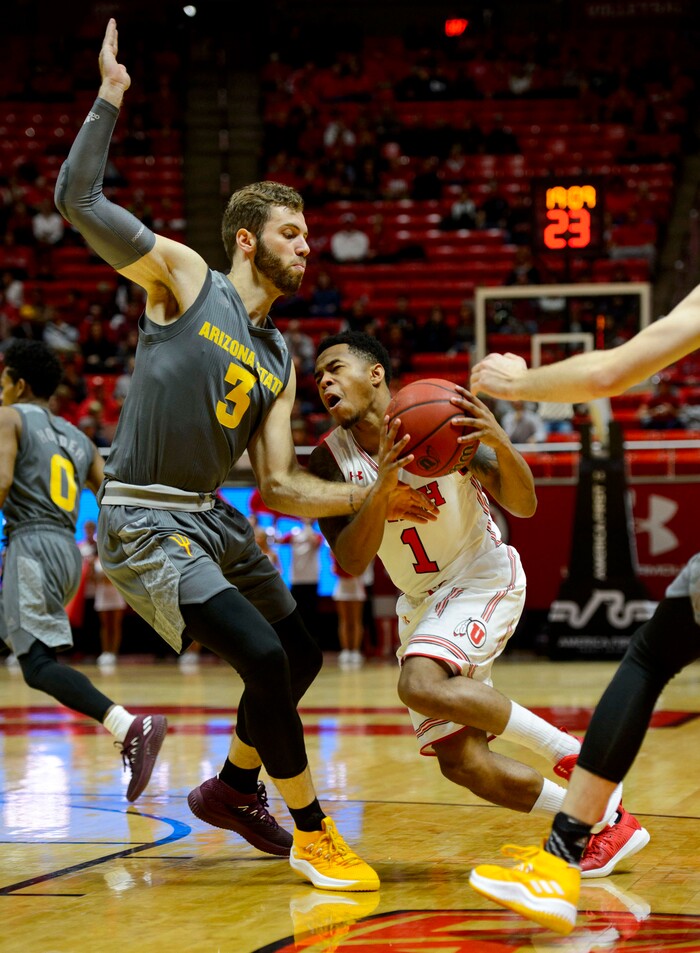 (Steve Griffin  |  The Salt Lake Tribune) Utah Utes guard Justin Bibbins (1) drives into the lane as Arizona State Sun Devils forward Mickey Mitchell (3) blocks his path during the Utah Utes versus Arizona State Sun Devils at the Huntsman Center on the University of Utah campus in Salt Lake City Sunday January 7, 2018.