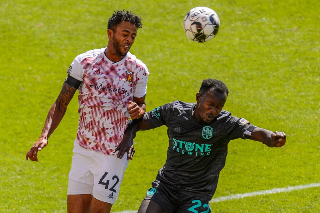 (Trent Nelson | The Salt Lake Tribune) Real Monarchs defender Taylor Peay heads the ball as the Real Monarchs host the San Diego Loyal SC at Rio Tinto Stadium in Sandy on Saturday, July 11, 2020. At right is San Diego Loyal forward Francis Atuahene.