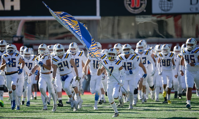 (Francisco Kjolseth  |  The Salt Lake Tribune)  Orem takes to the field before their game against Dixie in the 4A high school championship game at Rice Eccles Stadium in Salt Lake City, Friday, Nov. 16, 2018.