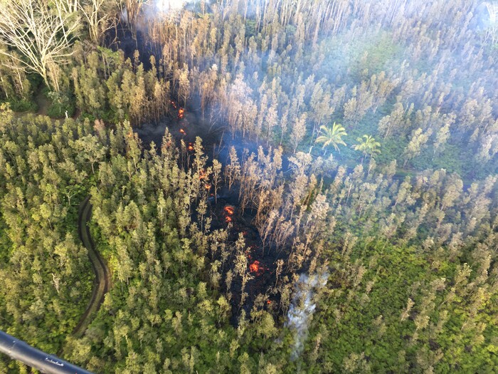 In this photo released by U.S. Geological Survey, lava is shown burning in Leilani Estates subdivision near the town of Pahoa on Hawaii's Big Island Thursday, May 3, 2018 in Hawaii Volcanoes National Park. Kilauea volcano erupted Thursday, sending lava shooting into the air in the residential neighborhood and prompting mandatory evacuation orders for nearby residents. (U.S. Geological Survey via AP)