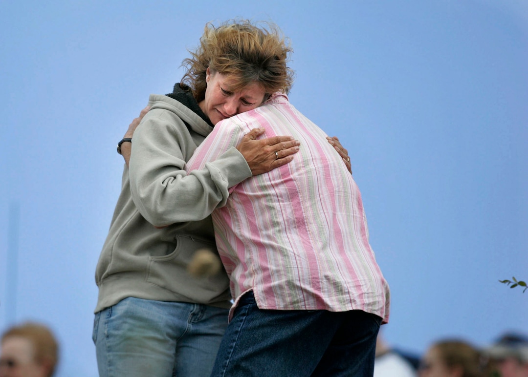 (Scott Sommerdorf  |  The Salt Lake Tribune)  Wendy Black, widow of fallen rescuer Dale Black, hugs a friend just prior to releasing a six-month old golden eagle from the top of the Wasatch Plateau. Friends and family of the miners  sent prayers for their loved ones to the heavens on the wings of the rehabilitated young eagle, a spiritually rewarding moment in an otherwise devastating time.