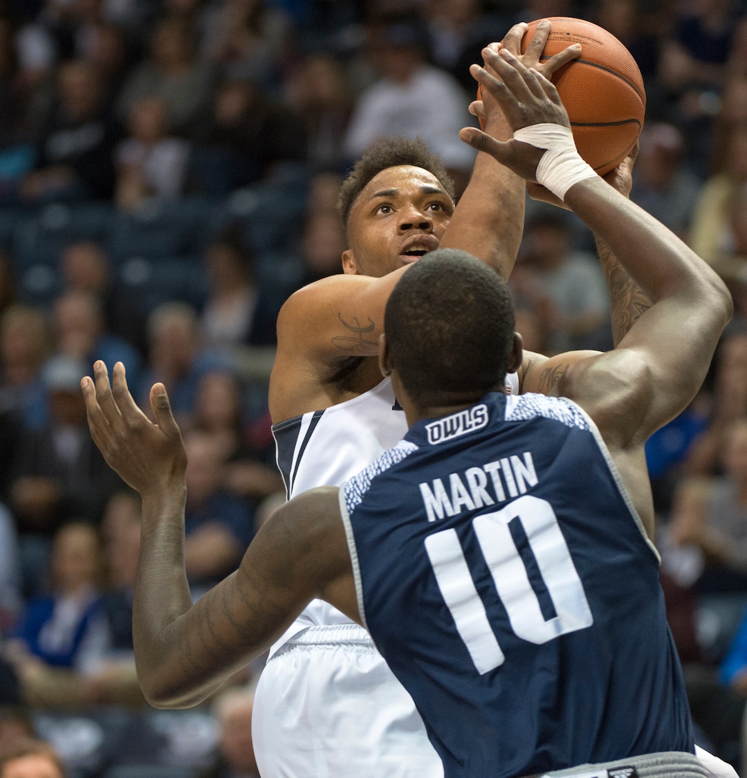 (Rick Egan  |  The Salt Lake Tribune)   Brigham Young Cougars guard Jahshire Hardnett (0) shoots over Rice Owls forward Robert Martin (10), in basketball action between Brigham Young Cougars and Rice Owls, at the Marriott Center in Provo, Wednesday, Nov. 21, 2018.