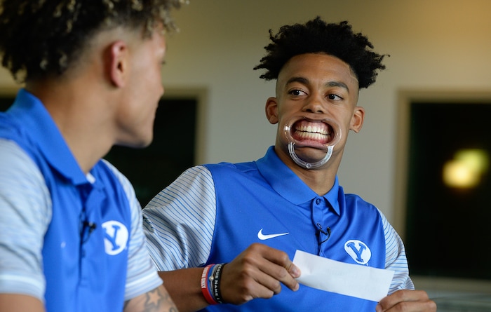 (Francisco Kjolseth  |  The Salt Lake Tribune)  BYU receiver Micah Simon, right, attempts to play the game "Speak Out" with teammate Troy Warner as BYU hosts their eighth-annual football media day at the BYU-Broadcasting Building on Friday, June 22, 2018.
