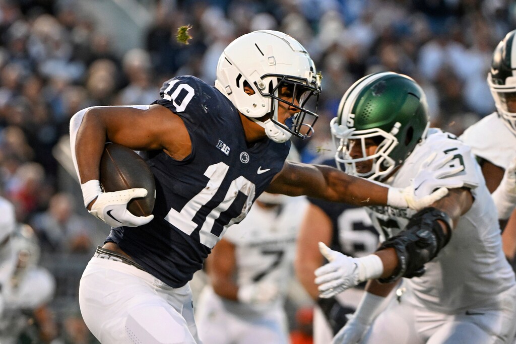 (Barry Reeger | AP) Penn State running back Nicholas Singleton (10) stiff arms Michigan State safety Xavier Henderson (3) during the first half of an NCAA college football game, Saturday, Nov. 26, 2022, in State College, Pa.