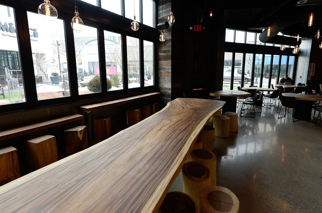 (Francisco Kjolseth  |  The Salt Lake Tribune)  The 32-foot communal table, made from acacia wood from Thailand, graces the seating area at HallPass.