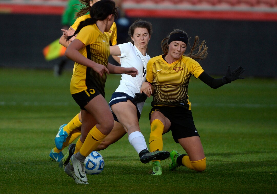 (Scott Sommerdorf   |  The Salt Lake Tribune)   Tess Donaldson of Timpanogos, tries to take a shot while sandwiched by Maple Mountain defenders during first half play. Maple Mountain won the shootout period 5-4 after double overtime to win the 5A championship game over Timpanogos, Friday, October 20, 2017. 
