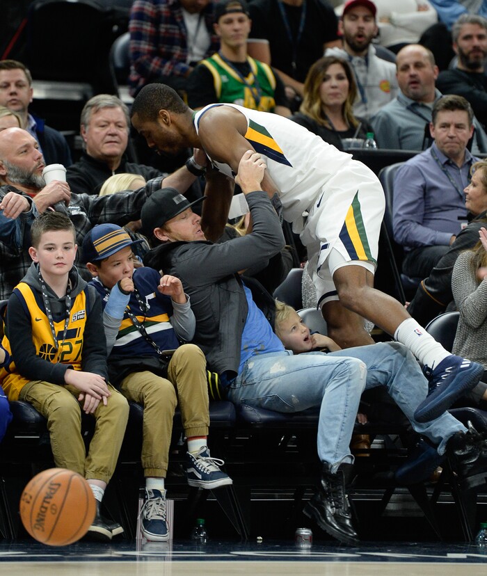 (Francisco Kjolseth  |  The Salt Lake Tribune)  Utah Jazz guard Rodney Hood (5) finds himself in the crowd after chasing down a ball over the Spurs during the second half of the NBA basketball game in Salt Lake City, Thursday, Dec. 21, 2017.