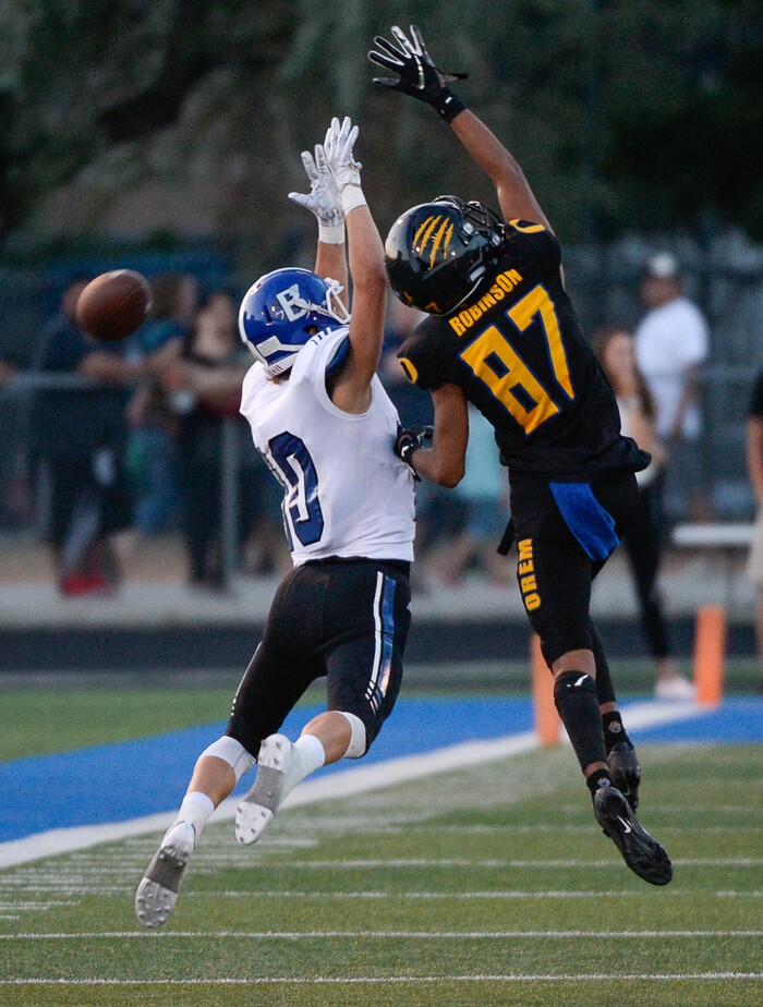 (Francisco Kjolseth  |  The Salt Lake Tribune)  Bingham's Luke Wilson is blocked by Orem's Jakob Robinson on a long pass attempt, Thursday, Aug. 16, 2018 in Orem.