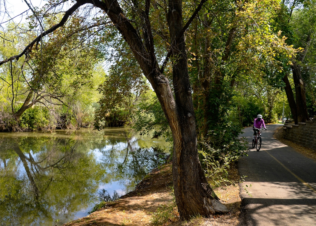 (Francisco Kjolseth  |  The Salt Lake Tribune) People recreate near the International Peace Gardens along the Jordan River Parkway on Wednesday, August 5, 2020, as new grant money becomes available to refresh the comprehensive master plan for the 51-mile parkway stretching from Utah Lake in Utah County to the wetlands of the Great Salt Lake.