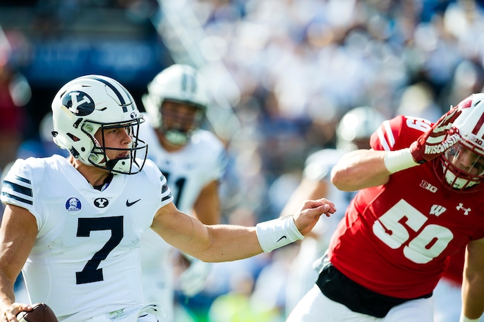 (Chris Detrick  |  The Salt Lake Tribune)  Brigham Young Cougars quarterback Beau Hoge (7) is chased down for a safety by Wisconsin Badgers linebacker Tyler Johnson (59) during the game at LaVell Edwards Stadium Saturday Saturday, September 16, 2017. Wisconsin Badgers defeated Brigham Young Cougars 40-6.